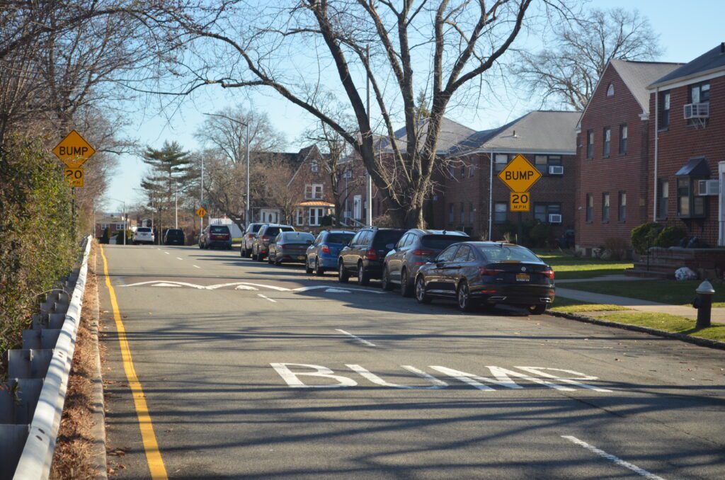 A line of cars parked on the side of a street.