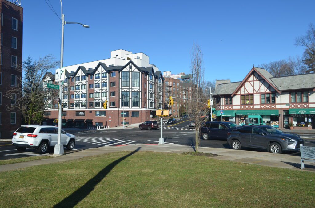 A street corner with cars parked on the side of it.