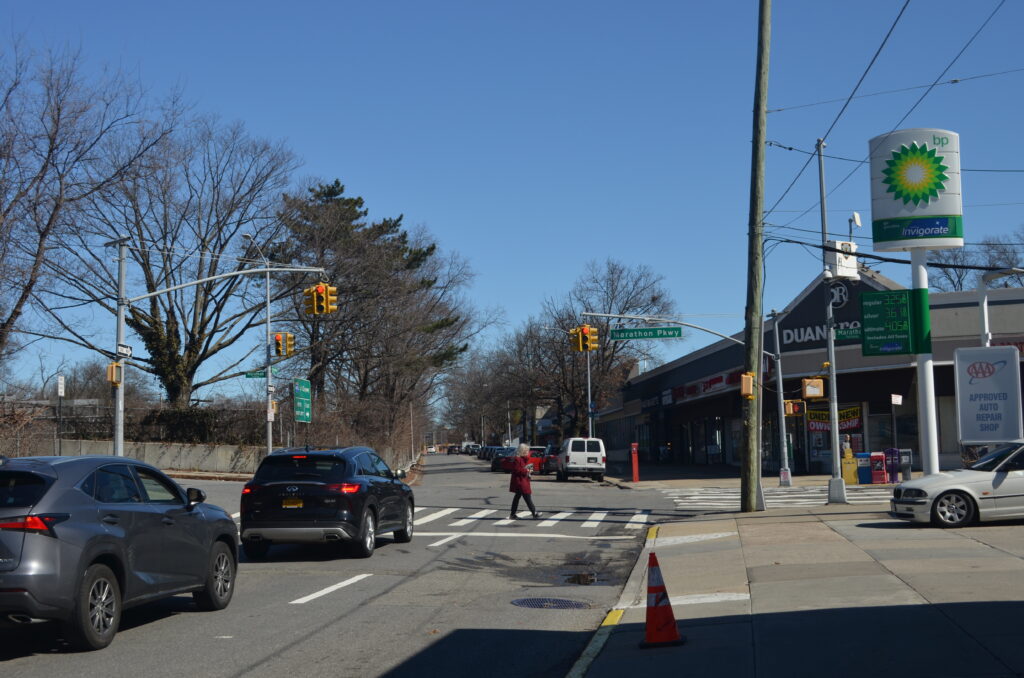 A person is crossing the street on a crosswalk.