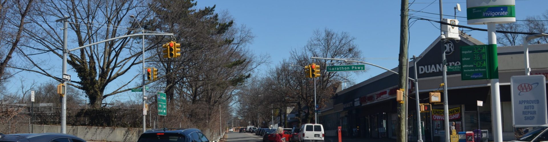 A person is crossing the street on a crosswalk.